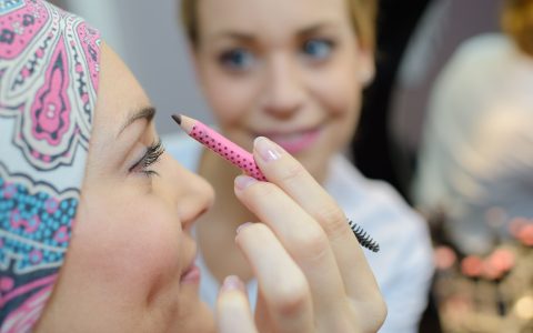 Beautician doing woman's eyebrows
